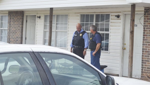 Atmore Public Safety Director Glenn Carlee and Capt. Bill Blair of the Escambia County Sheriff's Office talk after searching the Patterson Street apartments for two wanted murder suspects Tuesday.