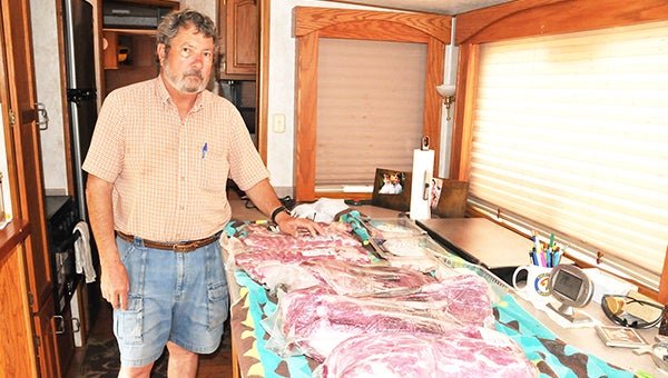 John Swift stands next to the meat he used to smoke at the Smokin in The Square event in Pensacola, Fla., over the weekend. | Andrew Garner/Atmore Advance
