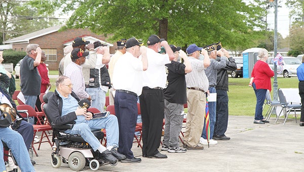 Veterans of the Vietnam War salute the American Flag during the Welcome Home event at Heritage Park Saturday afternoon. | Walt Butler/Atmore Advance